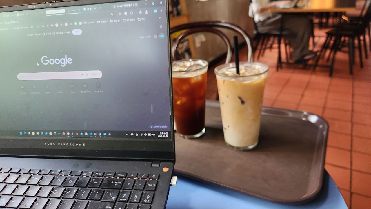 Laptop beside an iced Americano and iced latte at Brick Haus