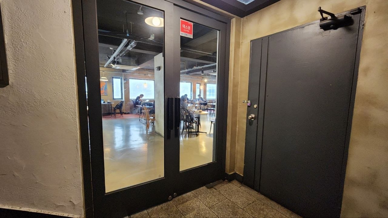 Glass entrance doors to the second-floor seating room at Brick Haus