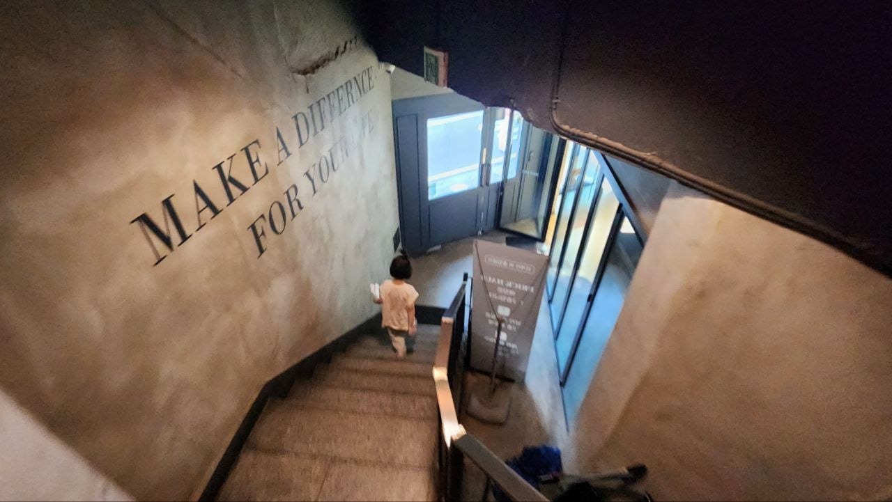 Our child walking down the internal stairs at Brick Haus