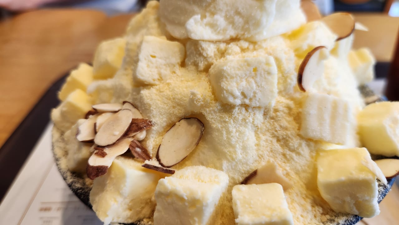 Korean cheese bingsu with cream cheese cubes and sliced almonds at Sulbing