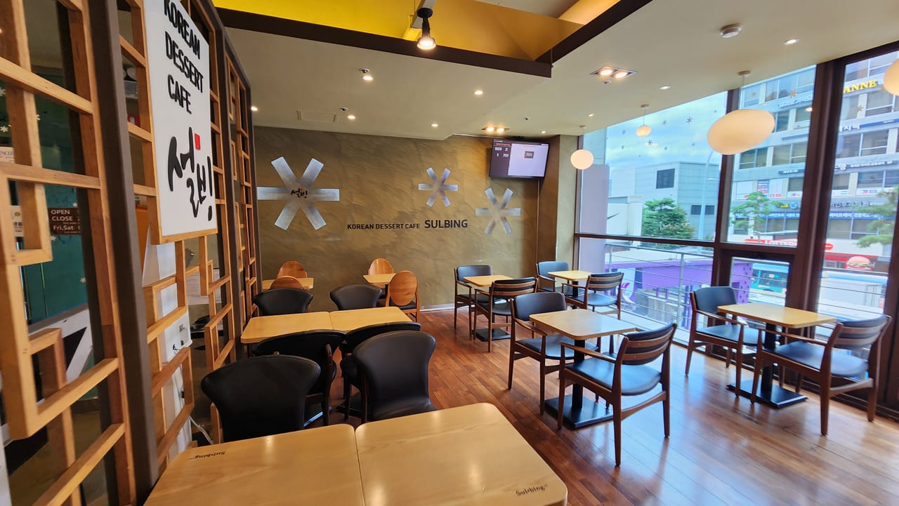 Wooden tables and window seating inside Sulbing Dongdaemun